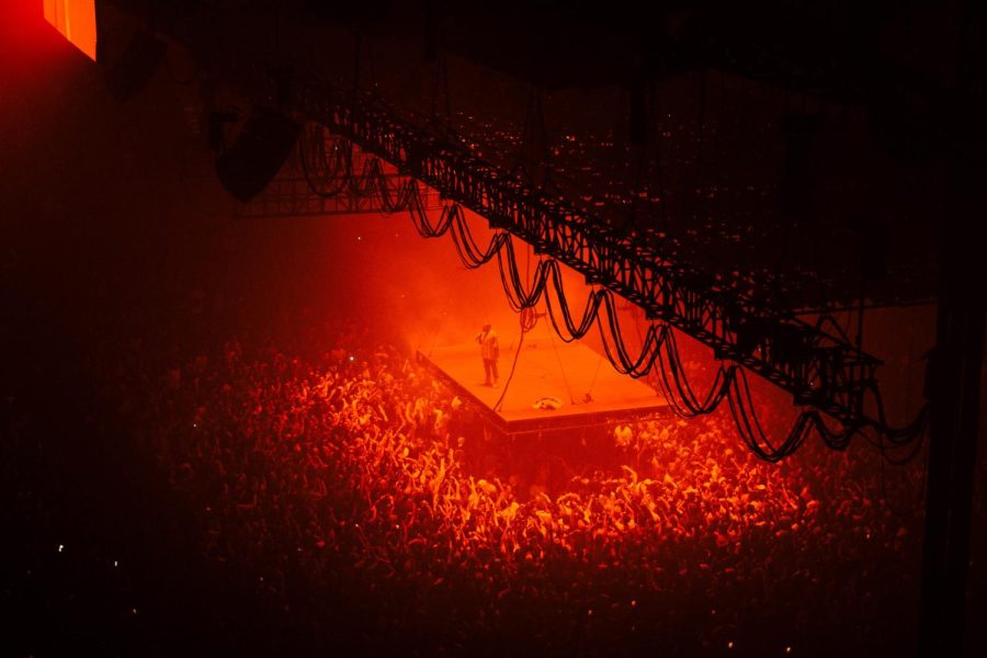Crowd of people in red light at Kanye West concert