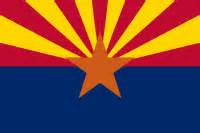 This image shows the Arizona state flag. An orange star in the center with the lower half a royal blue and the upper are stripes like a sunrise in yellow and red.