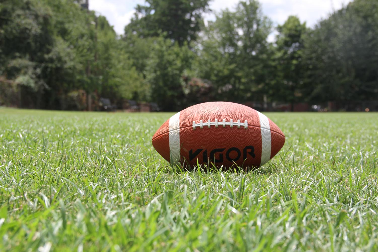 Football laying in a field of grass