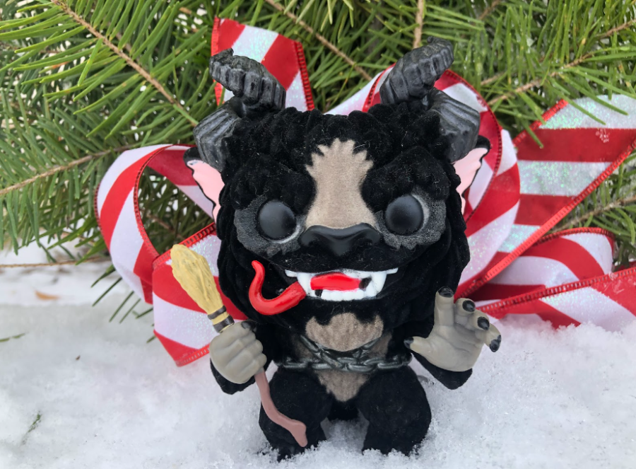 Krampus Funko Pop in snow in front of a festive wreath.