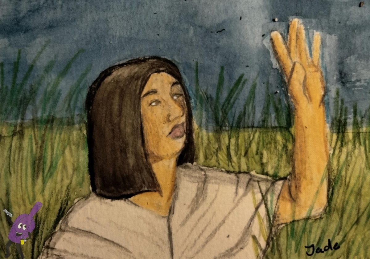Mitski in a field lifting her hand and looking at it 