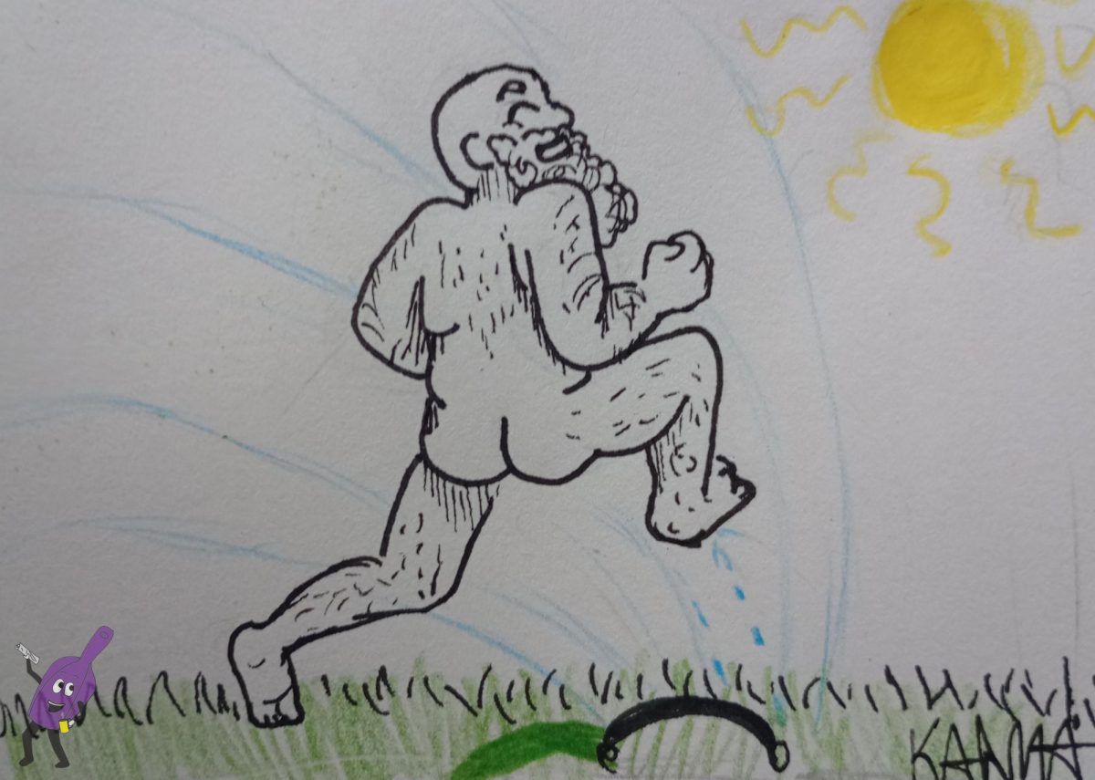 A grown man running through a sprinkler 
