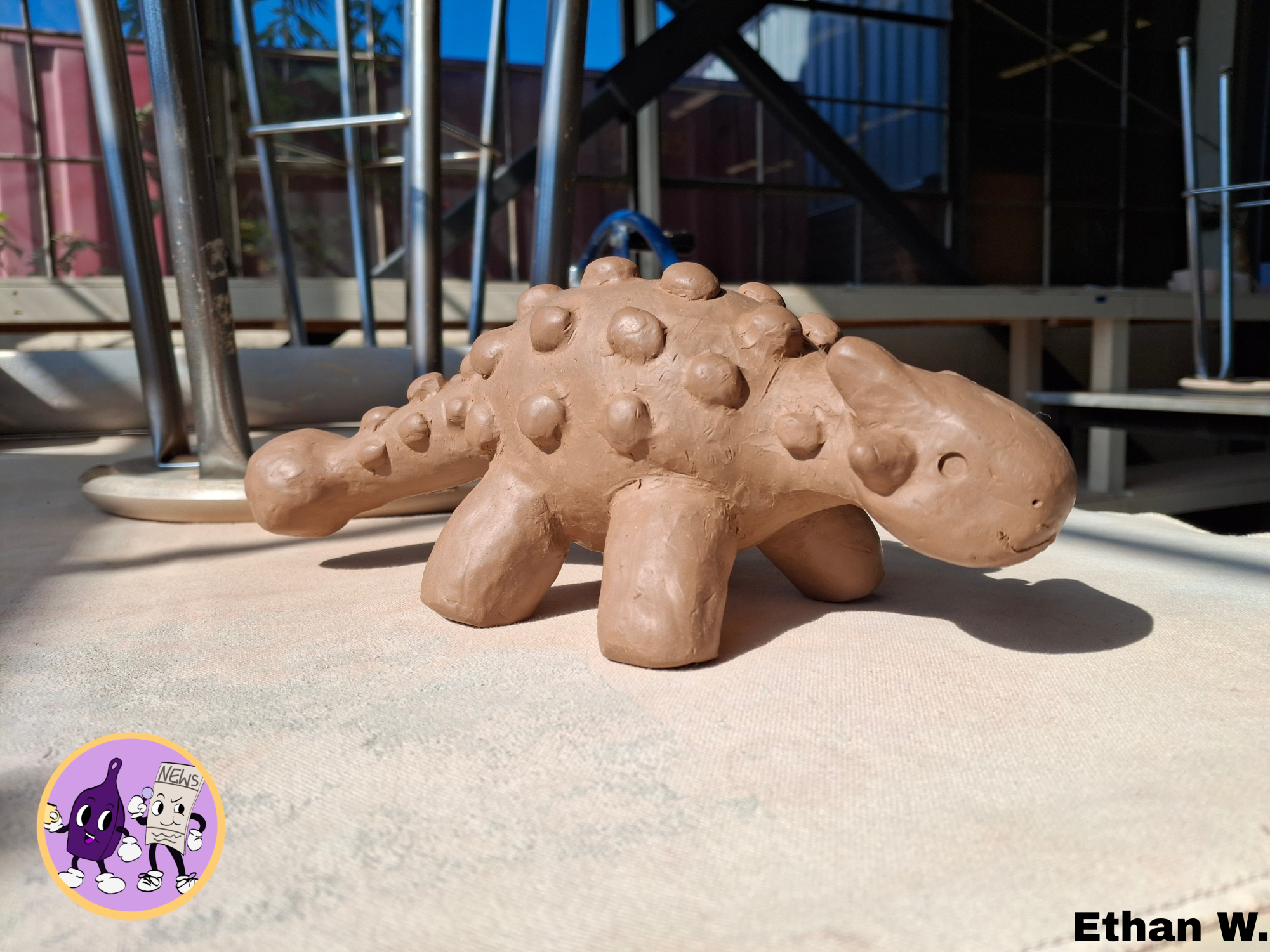 I sculpted a clay dinosaur in my ceramics class. It's based on the genus Ankylosaurus. It's as hot-blooded and fervent as it looks. It has yet to brave the kiln, so there is a possible chance it implodes and leaves a sad pile of soot where it stood. In the case of such a scenario, I took a picture in its honor. 