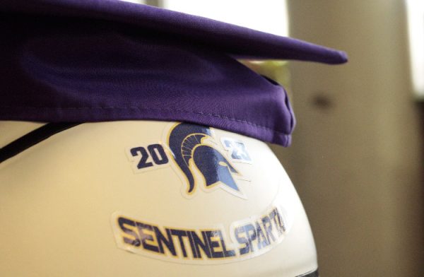 Sentinel's graduation cap sitting on a Sentinel Spartan basketball