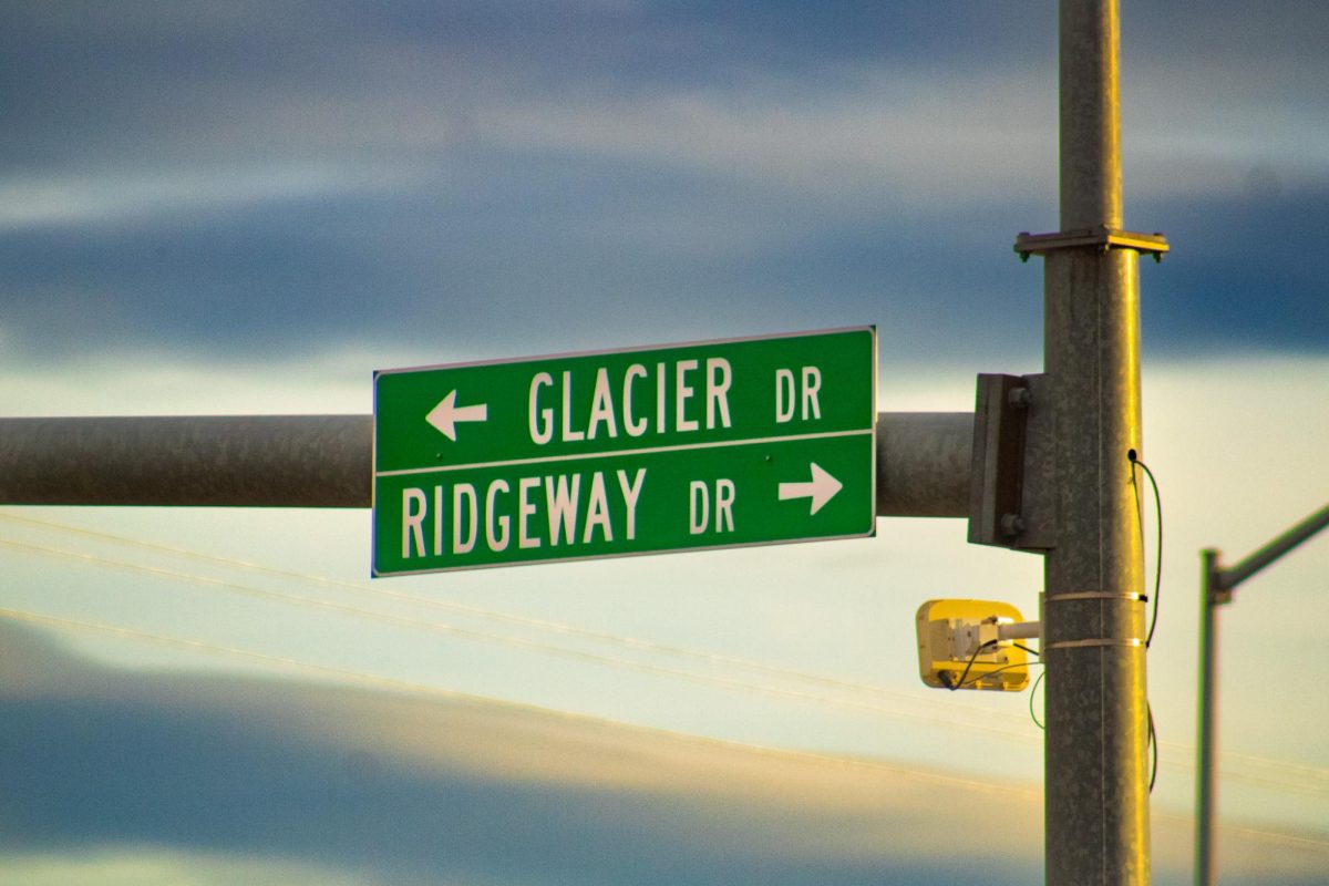A highway sign awaiting the sunset