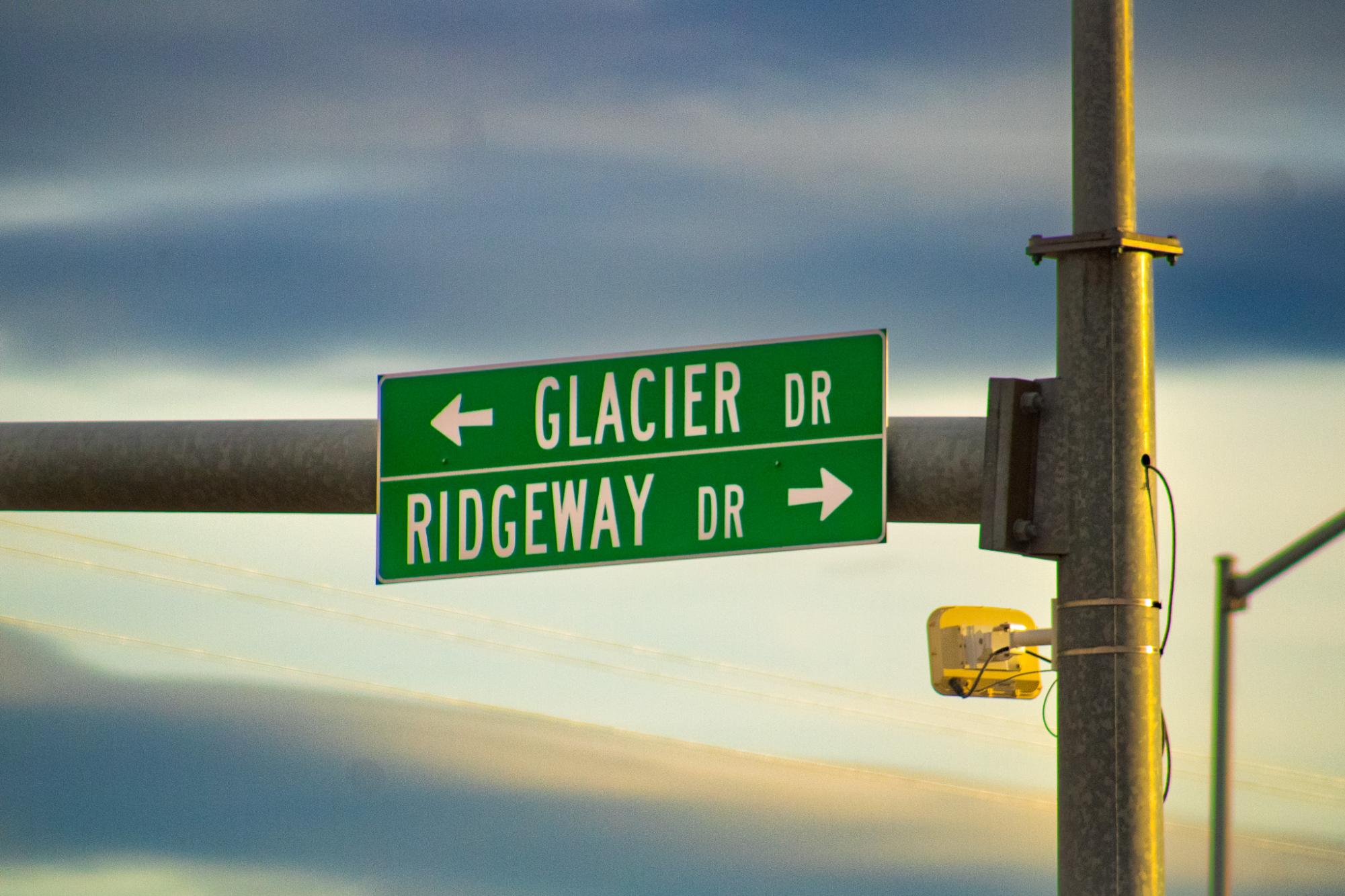 A highway sign awaiting the sunset