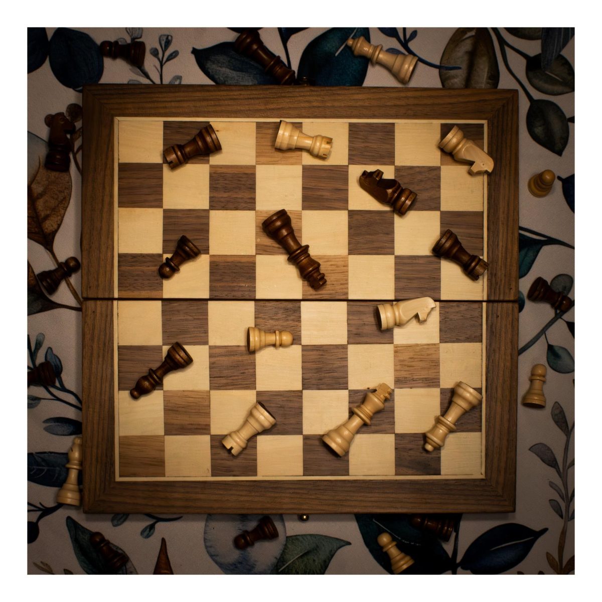 A chessboard covered with fallen chess pieces