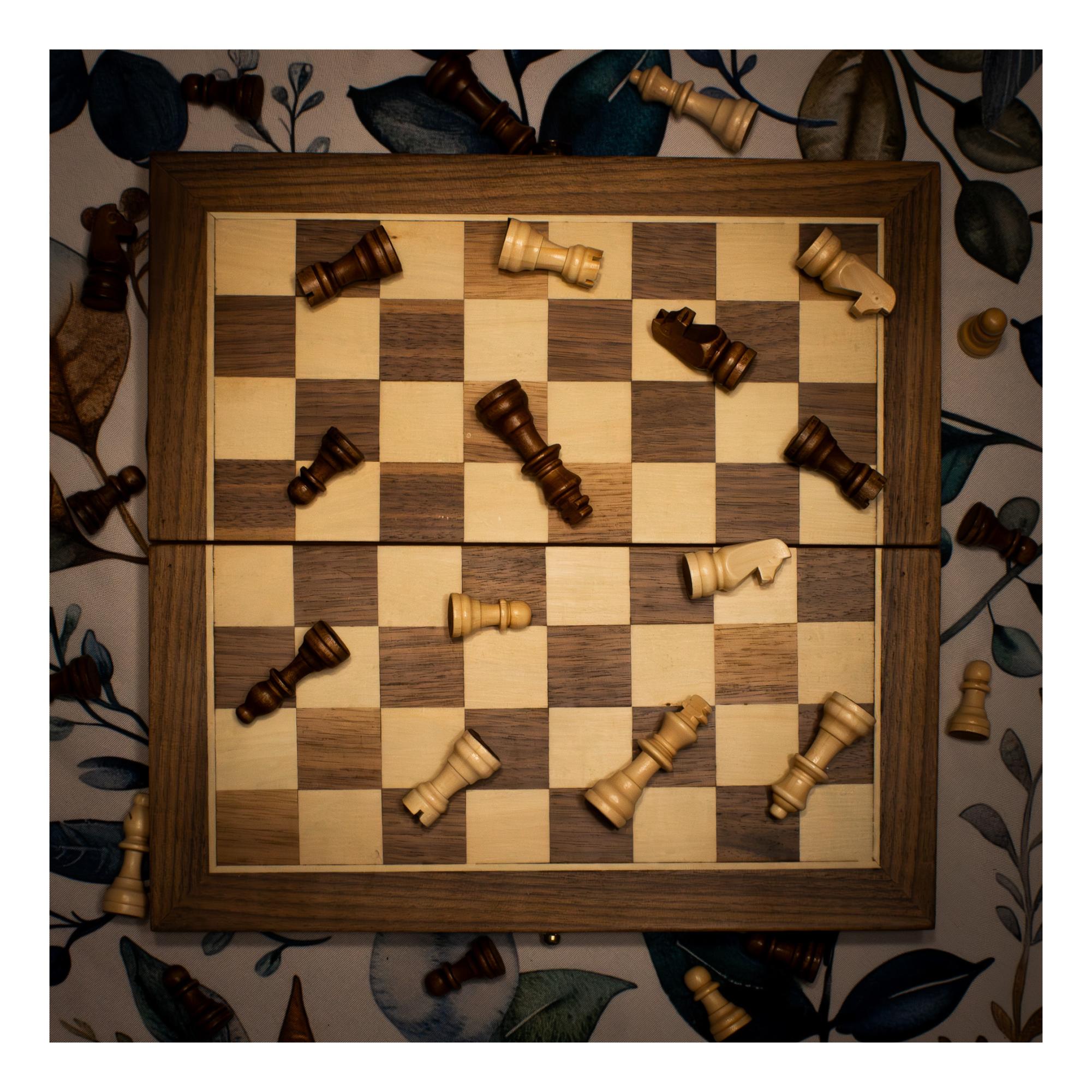 A chessboard covered with fallen chess pieces