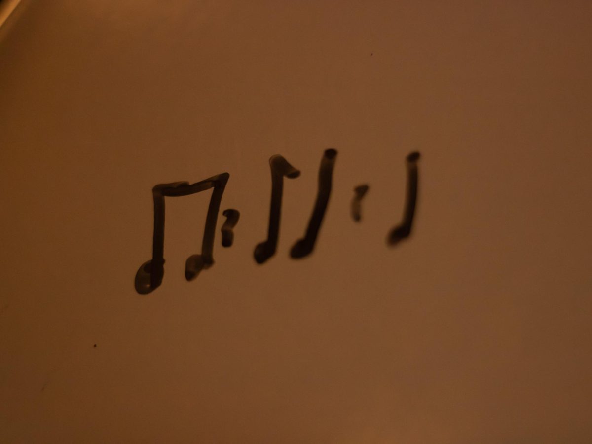 Written music notes in marker.