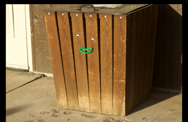 A trash bin with a smile on it